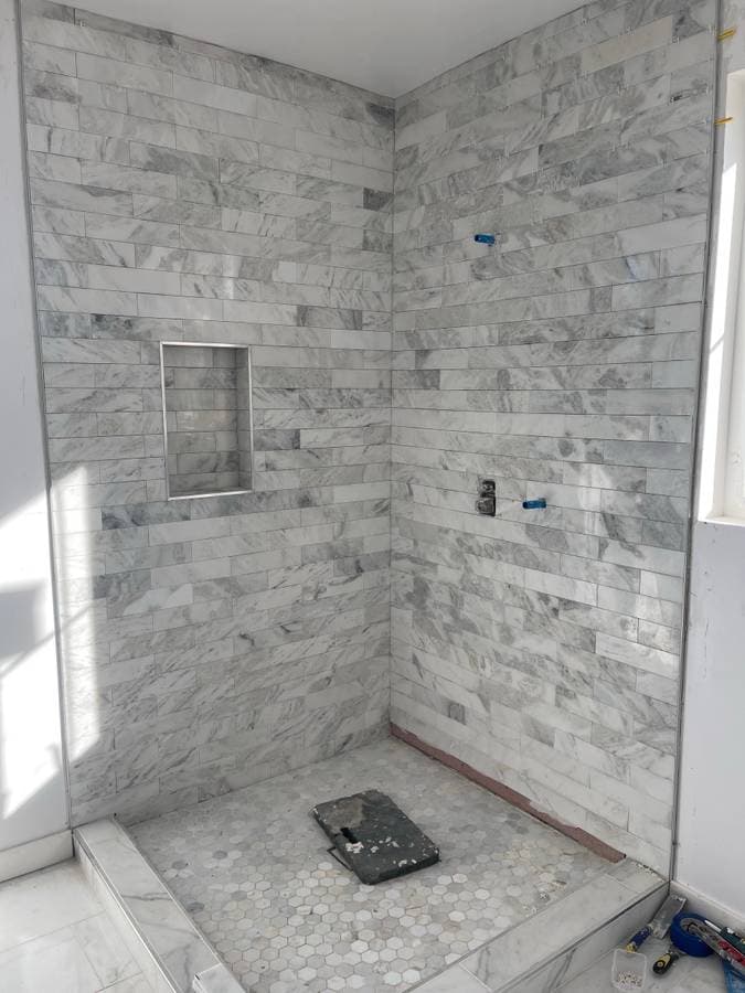 picture of a custom luxury shower remodel with textured tiles on the wall and floor